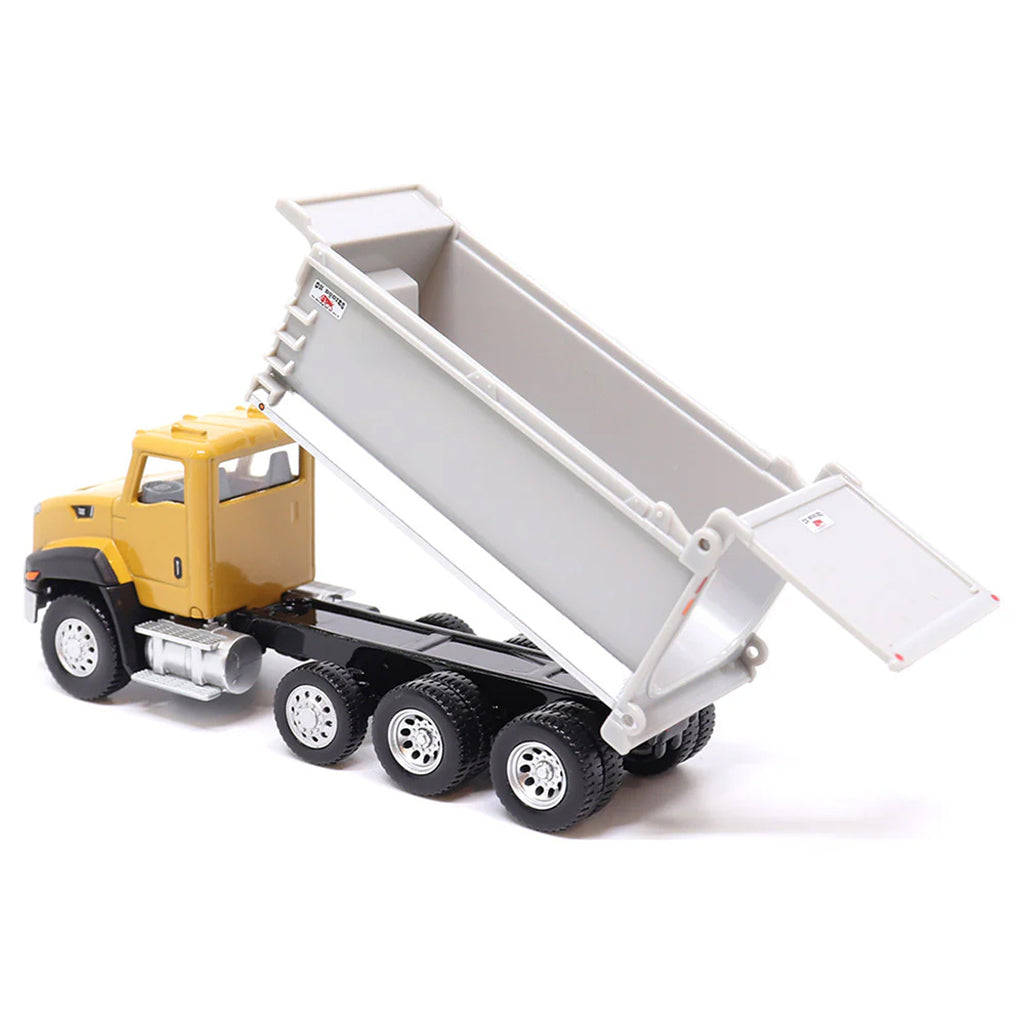 Toy CAT dump truck with yellow cab and gray bed on a white background