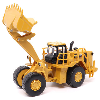 1:64th Scale Model of a CAT Yellow and Black Caterpillar 988H Wheel Loader on a White Background