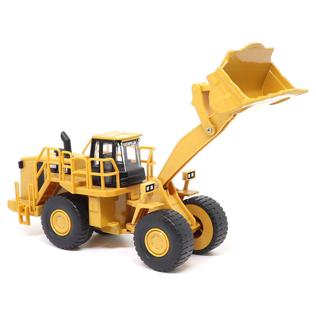 1:64th Scale Model of a CAT Yellow and Black Caterpillar 988H Wheel Loader on a White Background