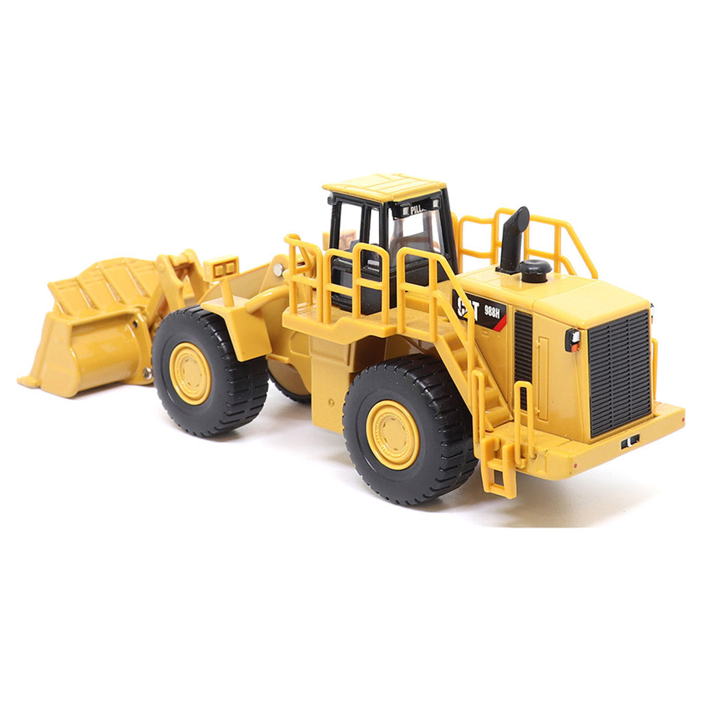 1:64th Scale Model of a CAT Yellow and Black Caterpillar 988H Wheel Loader on a White Background
