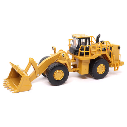 1:64th Scale Model of a CAT Yellow and Black Caterpillar 988H Wheel Loader on a White Background