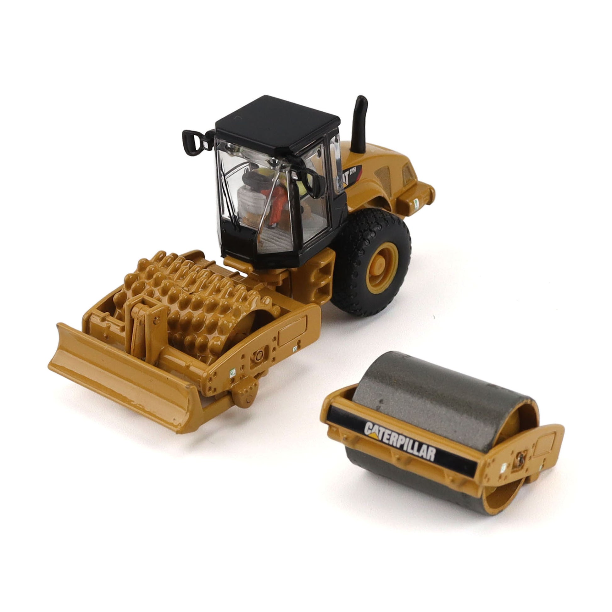 A toy construction vehicle set on a white background, featuring a yellow Caterpillar roller compactor with a black cab and a separate yellow and gray roller drum.