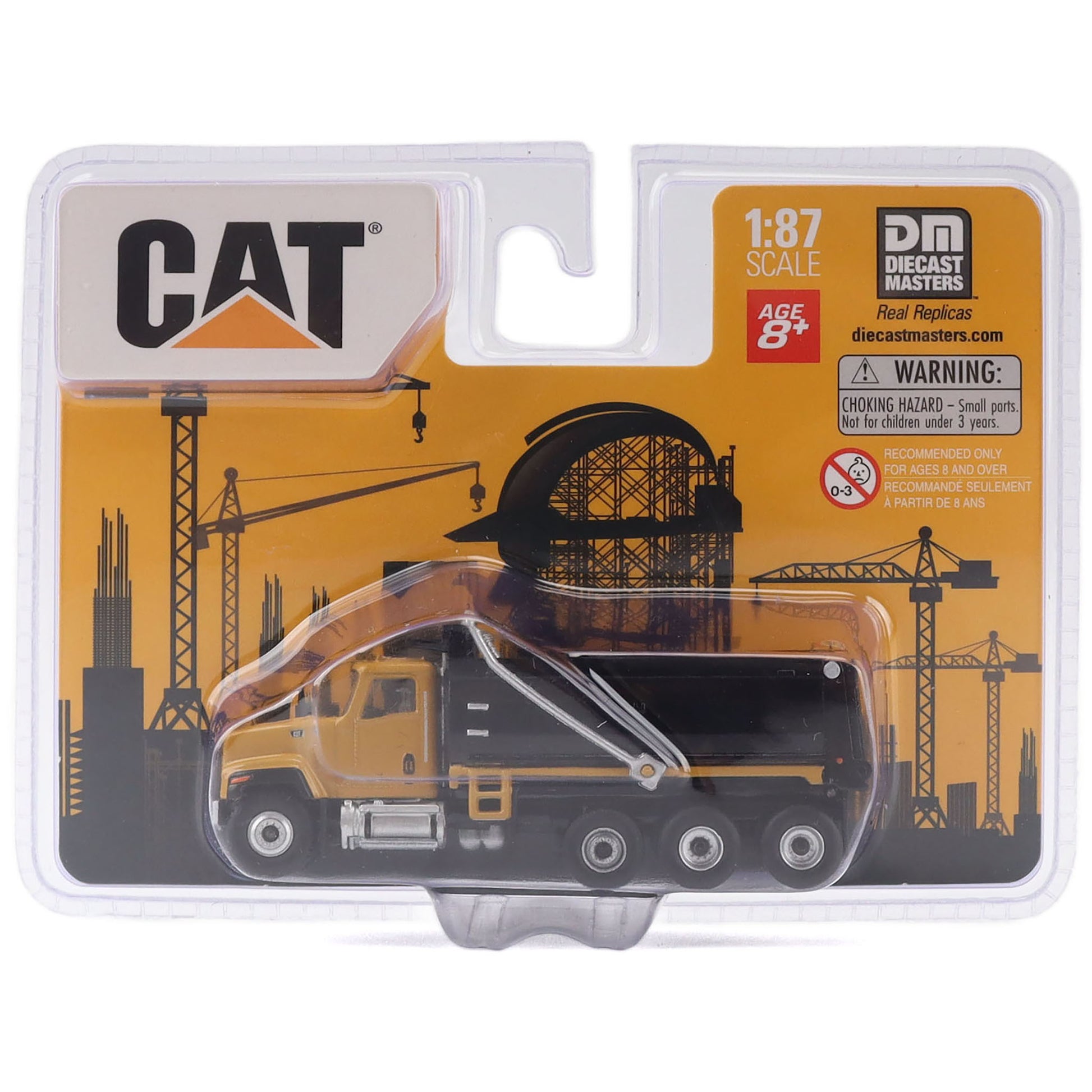 CAT 1:87 scale toy dump truck in its original blister packaging, featuring a yellow and black cab with a black dump bed and a construction-themed orange and black backing card.