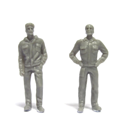 Two gray toy figures of men standing on a white background