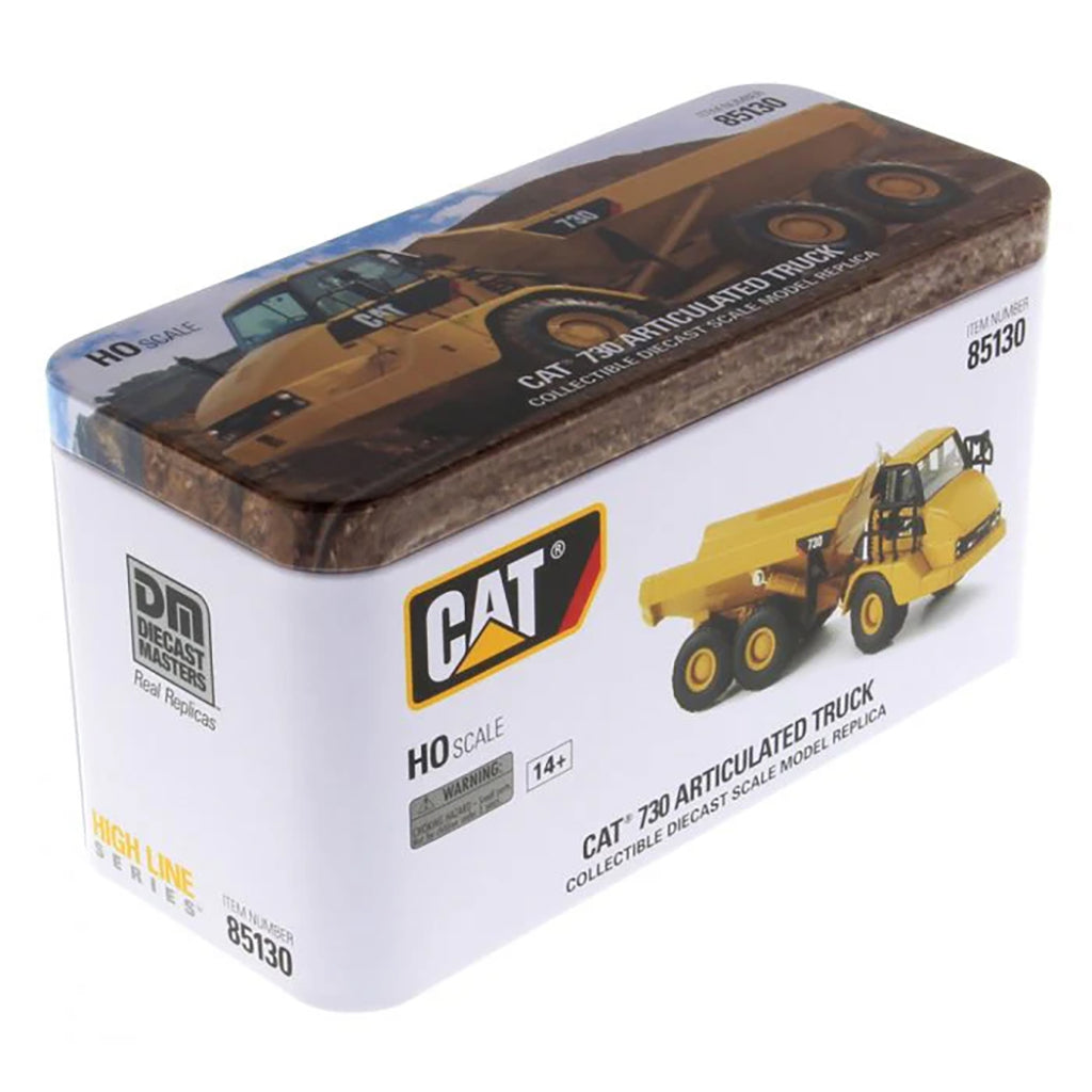 Model of a Caterpillar 730 Articulated Dump Truck in Tin Box Packaging on a White Background