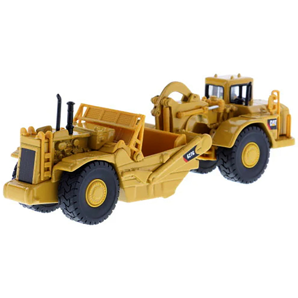Model of a Caterpillar 627G Wheel Tractor Scraper on a White Background