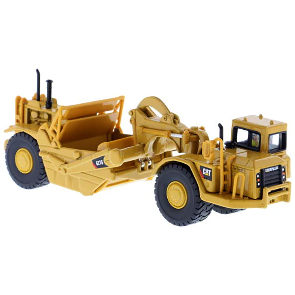 Model of a Caterpillar 627G Wheel Tractor Scraper on a White Background