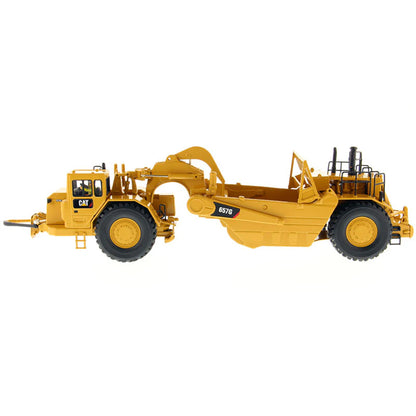 A yellow Caterpillar 657G Wheel Tractor Scraper toy vehicle with black and gray details, part of the High Line Series.