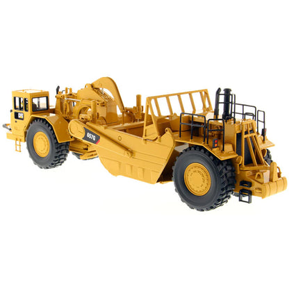 A yellow Caterpillar 657G Wheel Tractor Scraper toy vehicle with black and gray details, part of the High Line Series.