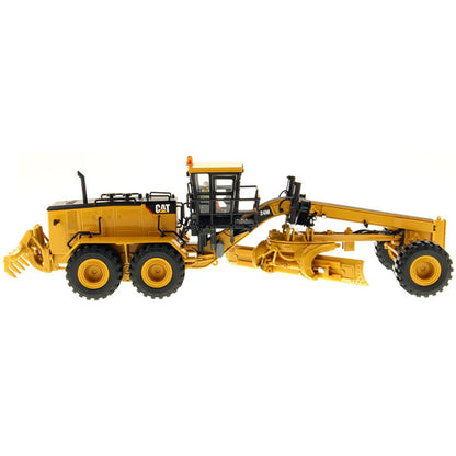 Model of a Caterpillar 24M Road Grader on a White Background