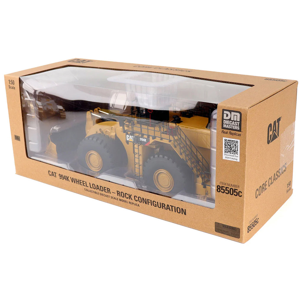 Boxed toy model of a Caterpillar 994K wheel loader on a white background