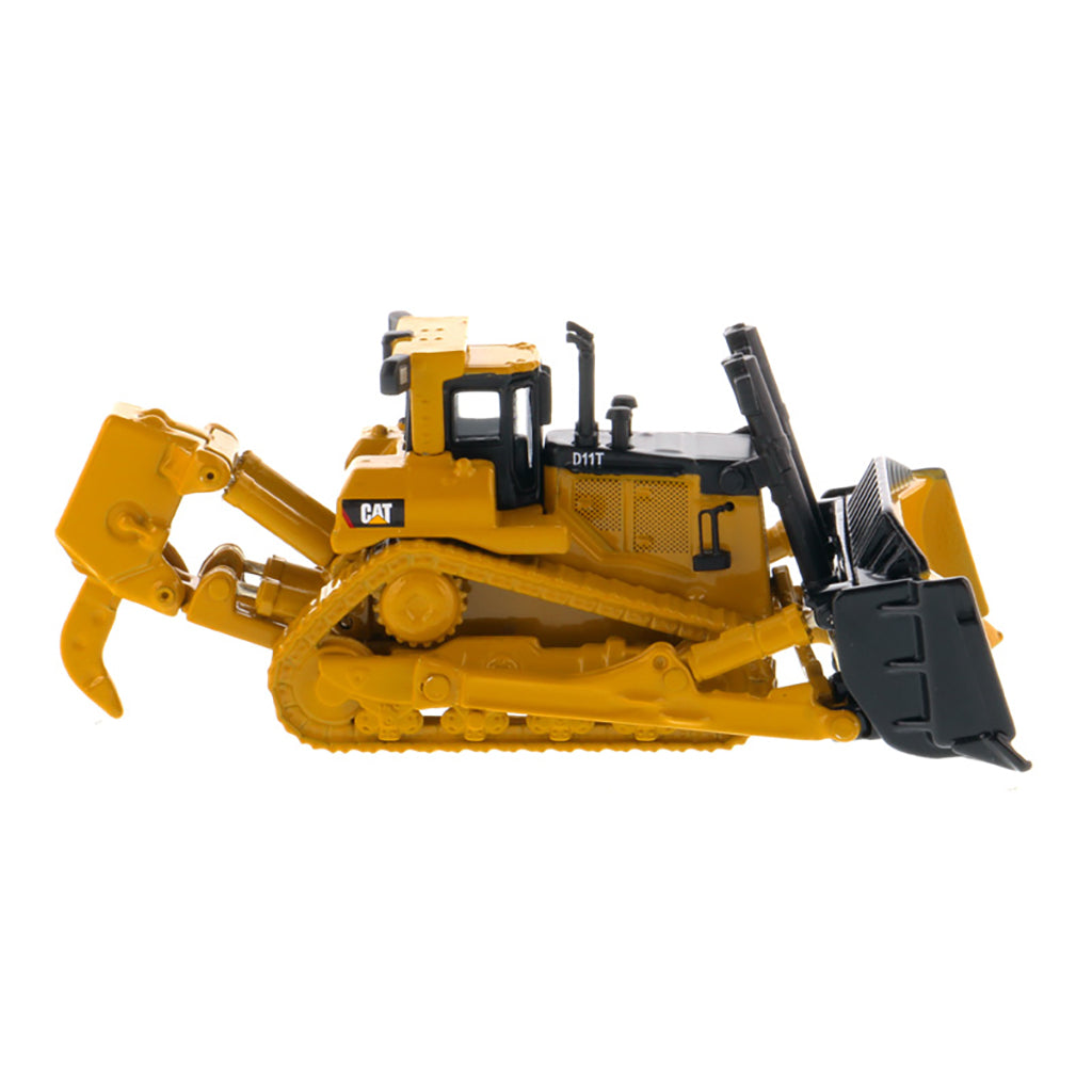 A yellow and black toy bulldozer model with a front blade and rear ripper attachment, photographed on a clean white background. The CAT logo is visible on the side.