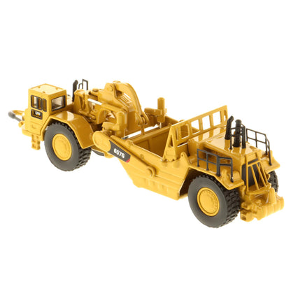 Model of a Caterpillar 657G Wheel Tractor Scraper on a White Background