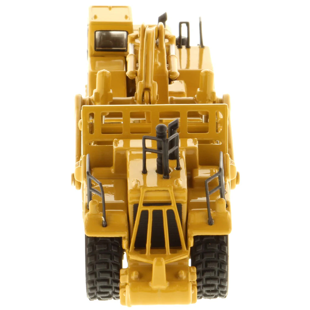 Model of a Caterpillar 657G Wheel Tractor Scraper on a White Background