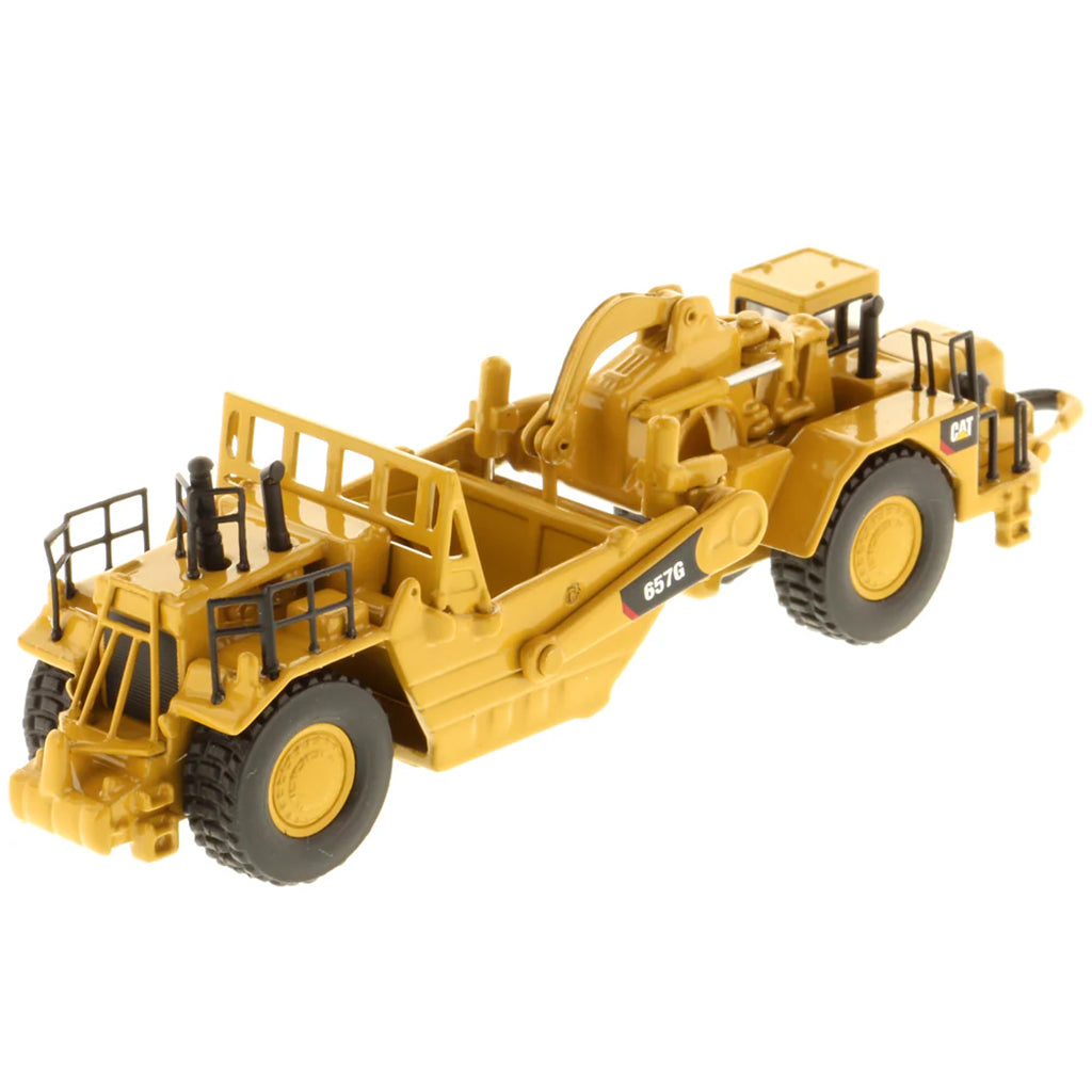 Model of a Caterpillar 657G Wheel Tractor Scraper on a White Background