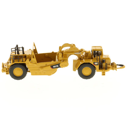 Model of a Caterpillar 657G Wheel Tractor Scraper on a White Background