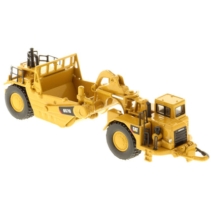 Model of a Caterpillar 657G Wheel Tractor Scraper on a White Background