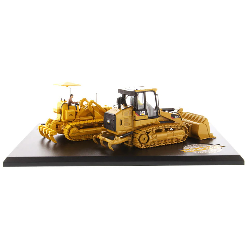 Two Caterpillar Track Loader Models on a Black Base and White Background