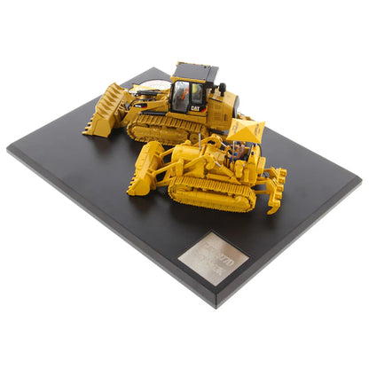 Two Caterpillar Track Loader Models on a Black Base and White Background