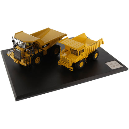Models of Caterpillar 769 Off Highway Dump Truck (1963-1965) & Caterpillar 770 Off Highway Dump Truck (2013-Current) Mounted on a Black Base on a White Background