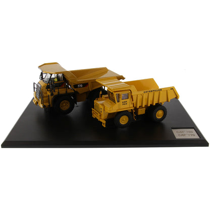 Models of Caterpillar 769 Off Highway Dump Truck (1963-1965) & Caterpillar 770 Off Highway Dump Truck (2013-Current) Mounted on a Black Base on a White Background
