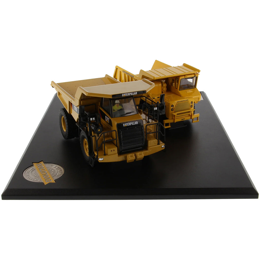 Models of Caterpillar 769 Off Highway Dump Truck (1963-1965) & Caterpillar 770 Off Highway Dump Truck (2013-Current) Mounted on a Black Base on a White Background