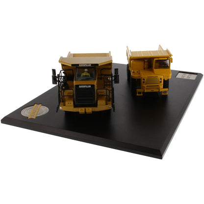 Models of Caterpillar 769 Off Highway Dump Truck (1963-1965) & Caterpillar 770 Off Highway Dump Truck (2013-Current) Mounted on a Black Base on a White Background