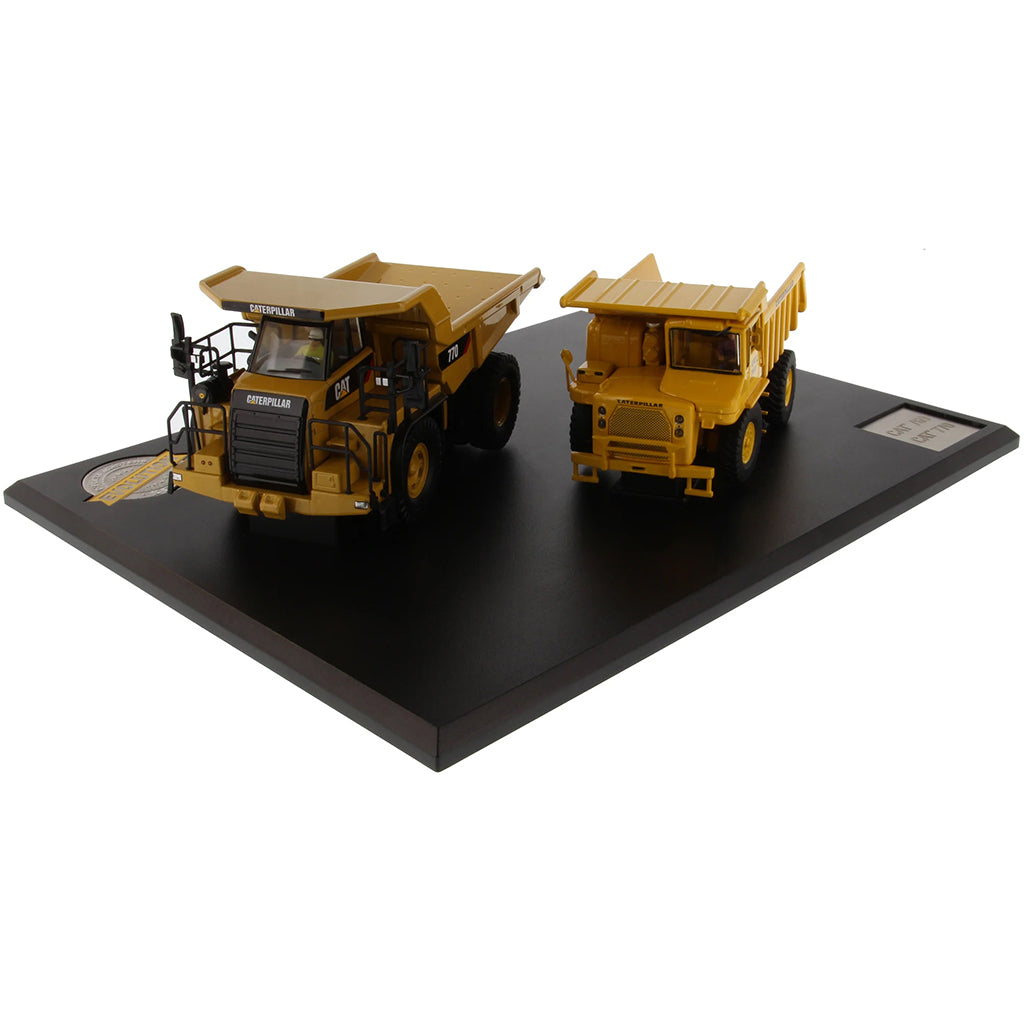 Models of Caterpillar 769 Off Highway Dump Truck (1963-1965) & Caterpillar 770 Off Highway Dump Truck (2013-Current) Mounted on a Black Base on a White Background