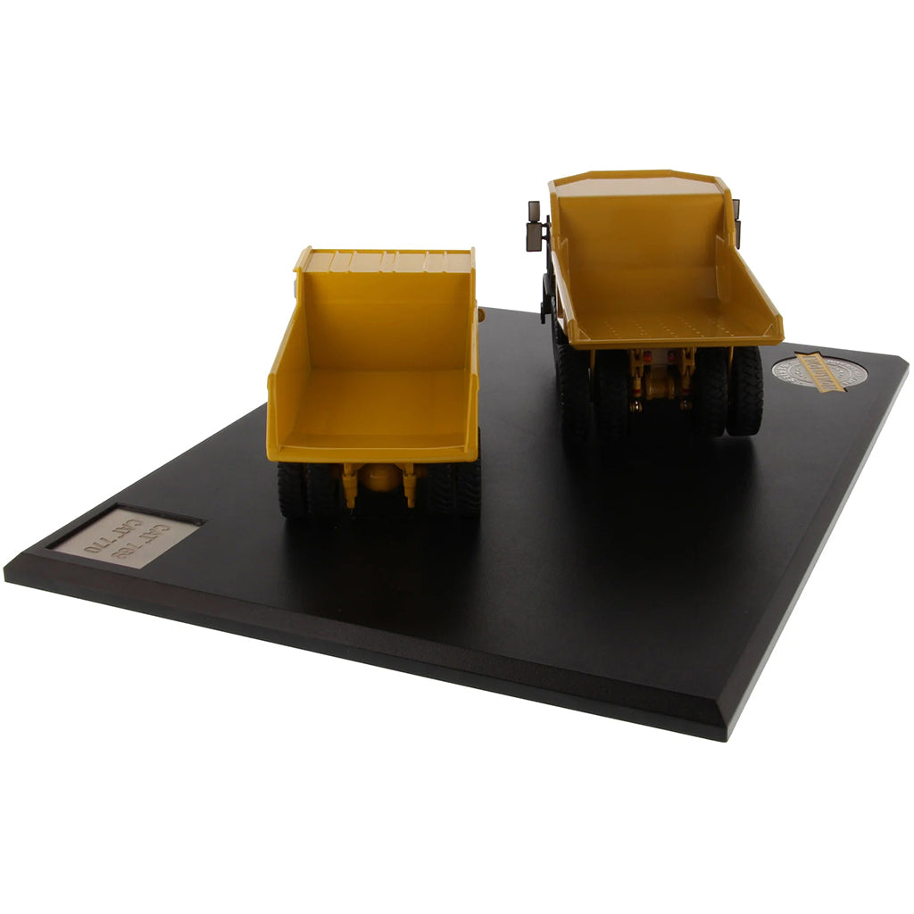 Models of Caterpillar 769 Off Highway Dump Truck (1963-1965) & Caterpillar 770 Off Highway Dump Truck (2013-Current) Mounted on a Black Base on a White Background
