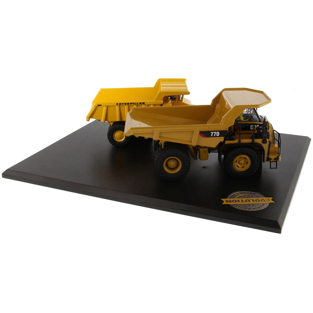 Models of Caterpillar 769 Off Highway Dump Truck (1963-1965) & Caterpillar 770 Off Highway Dump Truck (2013-Current) Mounted on a Black Base on a White Background