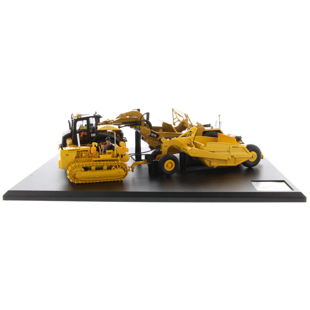 Models of Caterpillar D7 Track Type Tractor with No. 70 Scraper (1951-1957) &amp; Caterpillar 621K Scrape (2014-Current) Mounted on a Black Base on a White Background