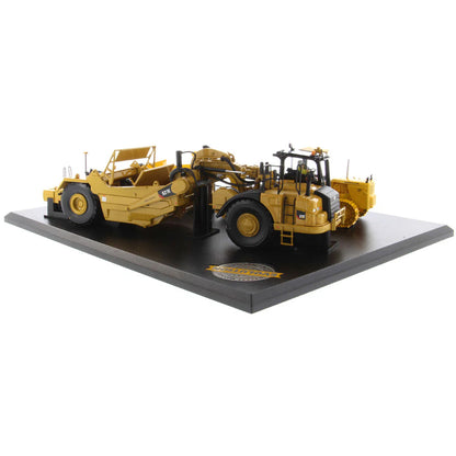 Models of Caterpillar D7 Track Type Tractor with No. 70 Scraper (1951-1957) &amp; Caterpillar 621K Scrape (2014-Current) Mounted on a Black Base on a White Background