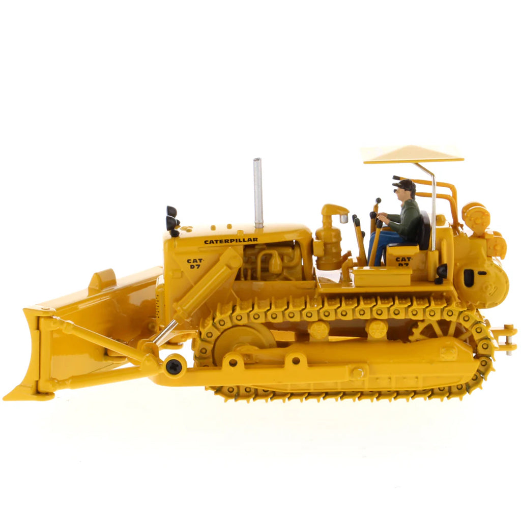 Model of a Vintage Yellow Caterpillar D7C Track-Type Dozer with Winch and Operator Figure on a White Background