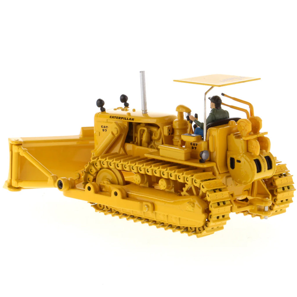 Model of a Vintage Yellow Caterpillar D7C Track-Type Dozer with Winch and Operator Figure on a White Background