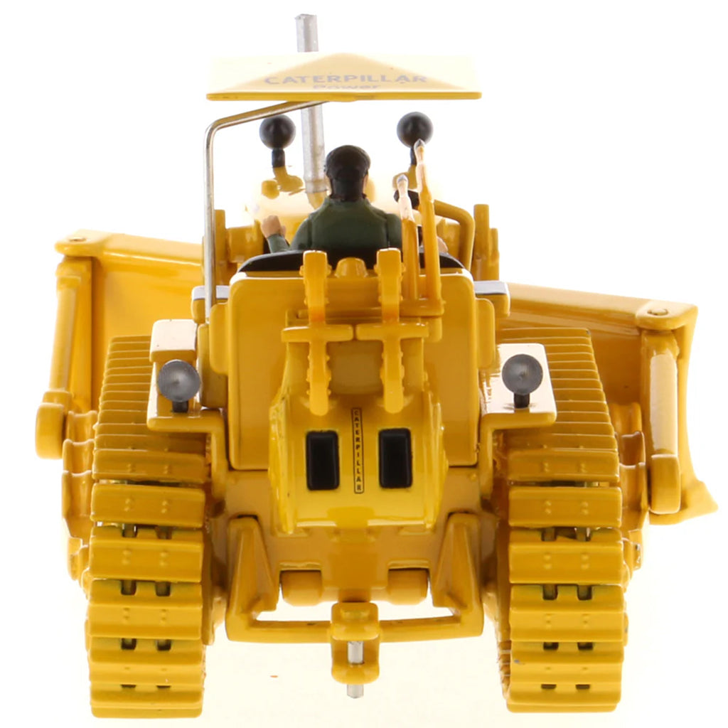 Model of a Vintage Yellow Caterpillar D7C Track-Type Dozer with Winch and Operator Figure on a White Background