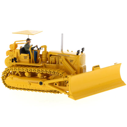 Model of a Vintage Yellow Caterpillar D7C Track-Type Dozer with Winch and Operator Figure on a White Background