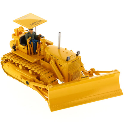 Model of a Vintage Yellow Caterpillar D7C Track-Type Dozer with Winch and Operator Figure on a White Background