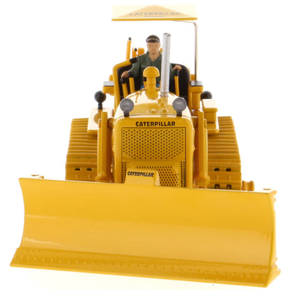 Model of a Vintage Yellow Caterpillar D7C Track-Type Dozer with Winch and Operator Figure on a White Background