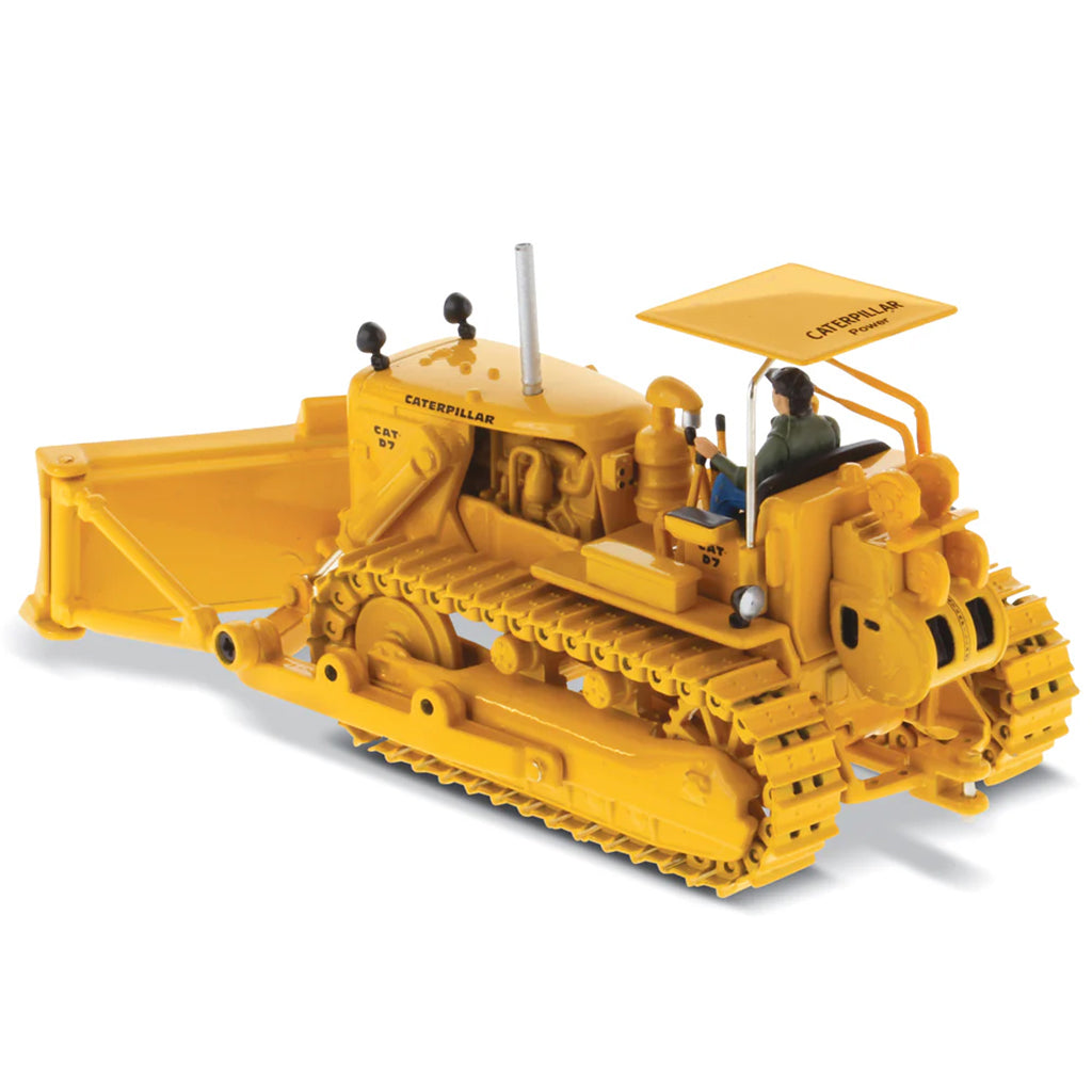 Model of a Vintage Yellow Caterpillar D7C Track-Type Dozer with Winch and Operator Figure on a White Background
