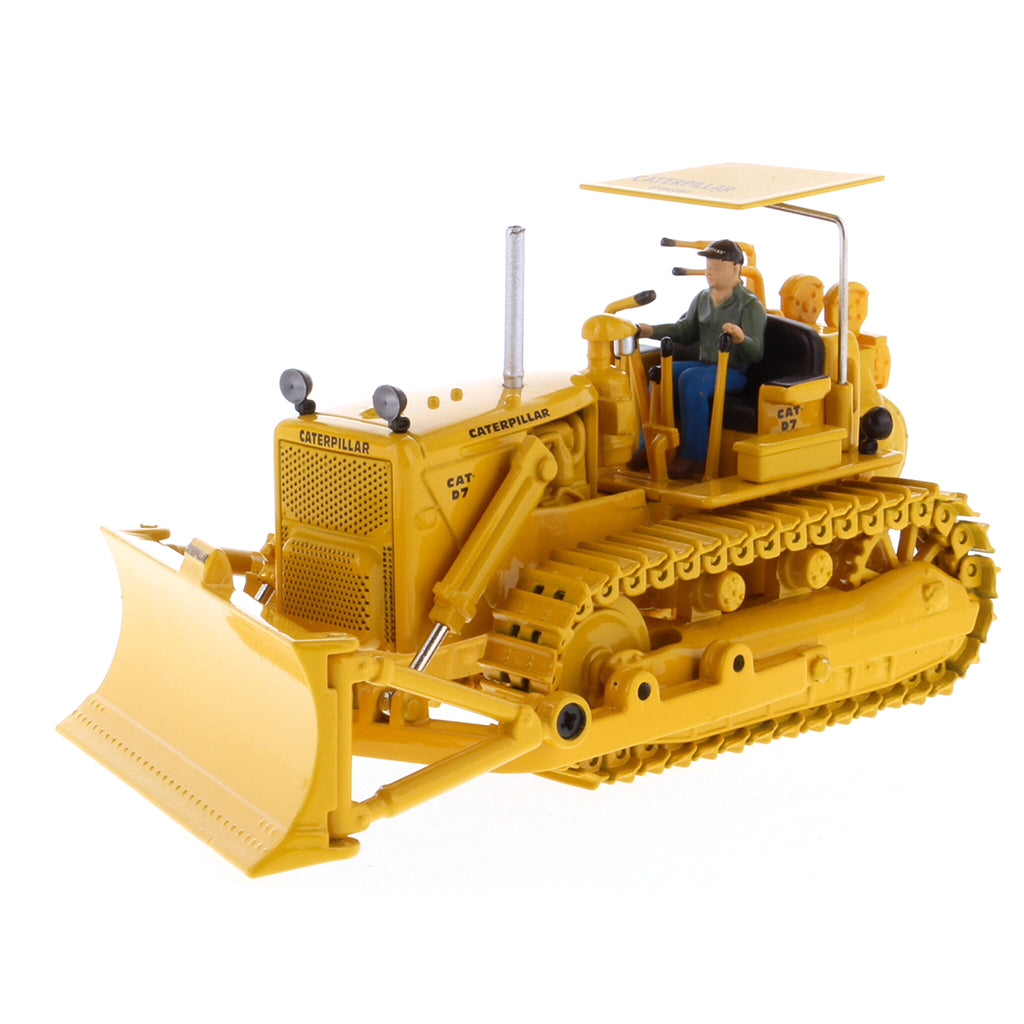 Model of a Vintage Yellow Caterpillar D7C Track-Type Dozer with Winch and Operator Figure on a White Background