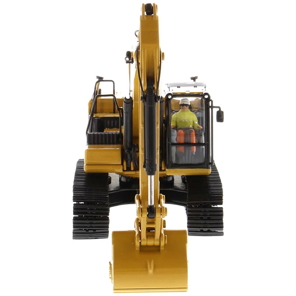 Model of a yellow excavator on a white background