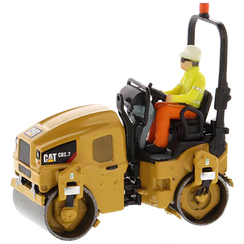 Model of a Caterpillar CB-2.7 Tandem Vibratory Road Roller with Operator on a White Background 