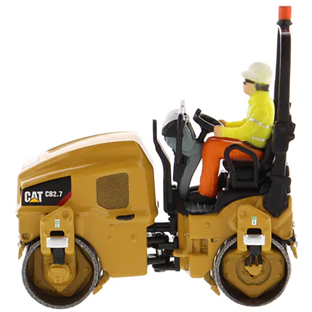 Model of a Caterpillar CB-2.7 Tandem Vibratory Road Roller with Operator on a White Background 