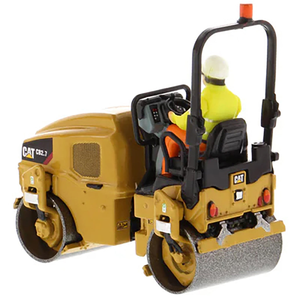 Model of a Caterpillar CB-2.7 Tandem Vibratory Road Roller with Operator on a White Background 