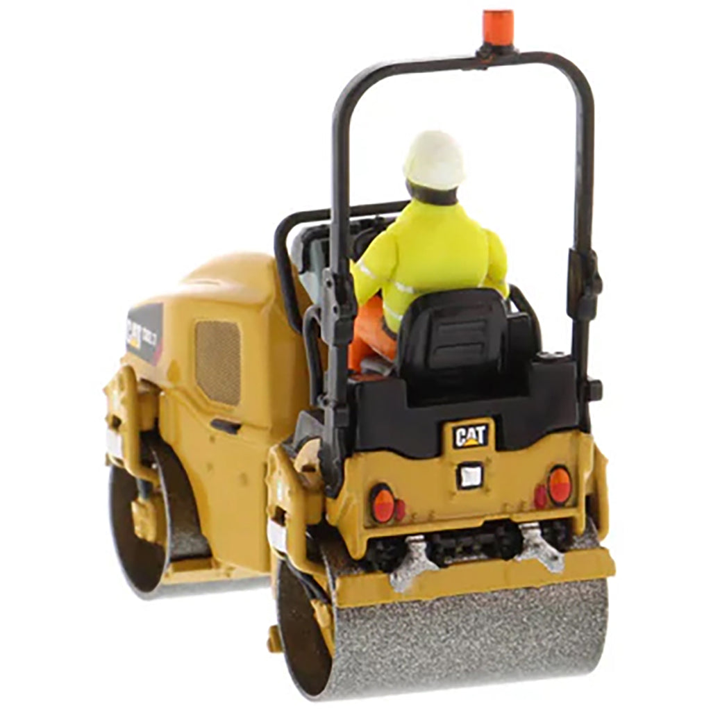 Model of a Caterpillar CB-2.7 Tandem Vibratory Road Roller with Operator on a White Background 