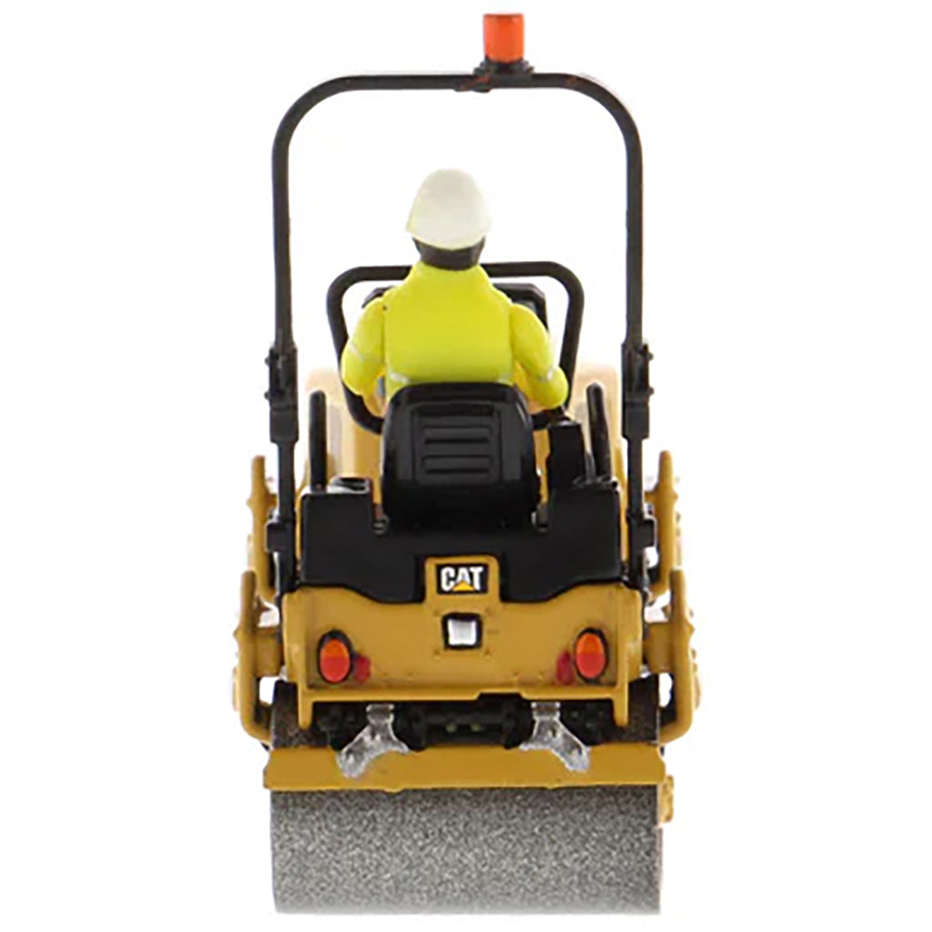 Model of a Caterpillar CB-2.7 Tandem Vibratory Road Roller with Operator on a White Background 
