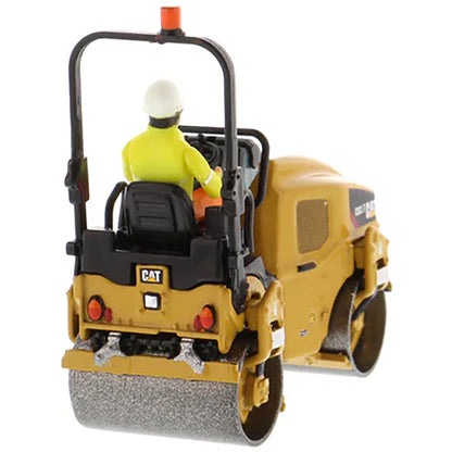 Model of a Caterpillar CB-2.7 Tandem Vibratory Road Roller with Operator on a White Background 
