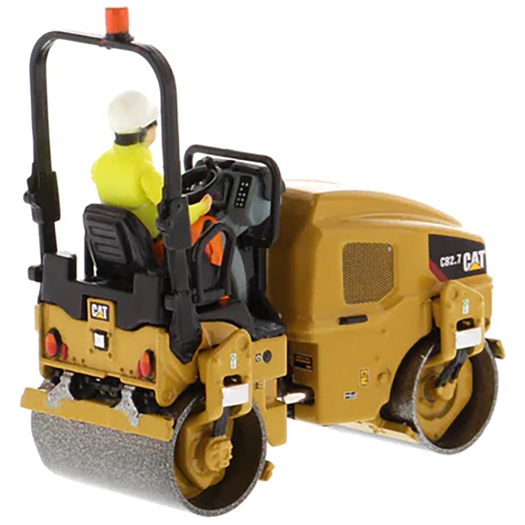 Model of a Caterpillar CB-2.7 Tandem Vibratory Road Roller with Operator on a White Background 
