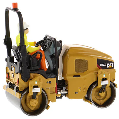 Model of a Caterpillar CB-2.7 Tandem Vibratory Road Roller with Operator on a White Background 