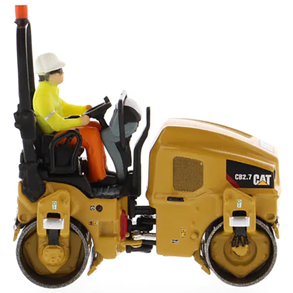 Model of a Caterpillar CB-2.7 Tandem Vibratory Road Roller with Operator on a White Background 